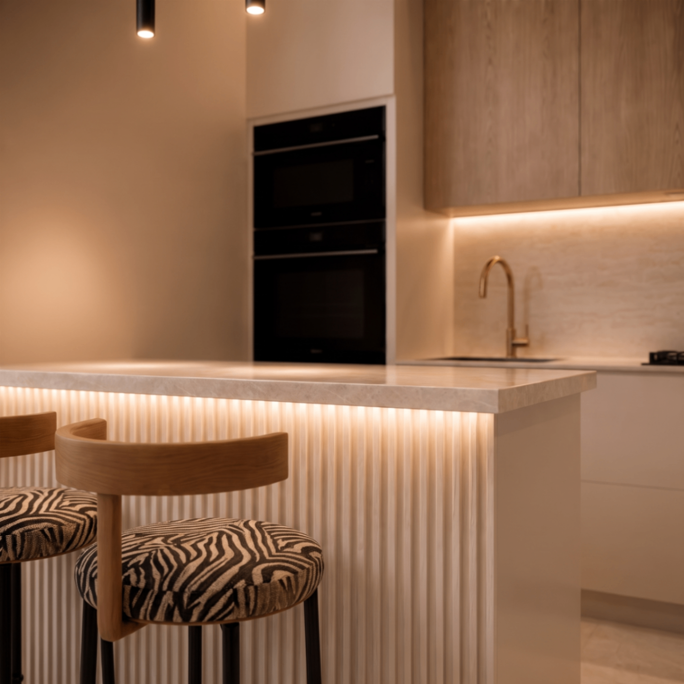 Interior: kitchen island detail with backlit fluting and bar stools