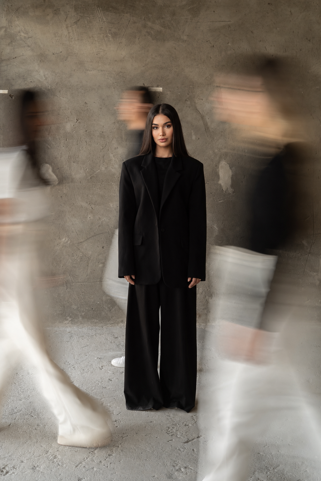 Meri Nanijanyan in an oversized black blazer, editorial motion-blur portrait